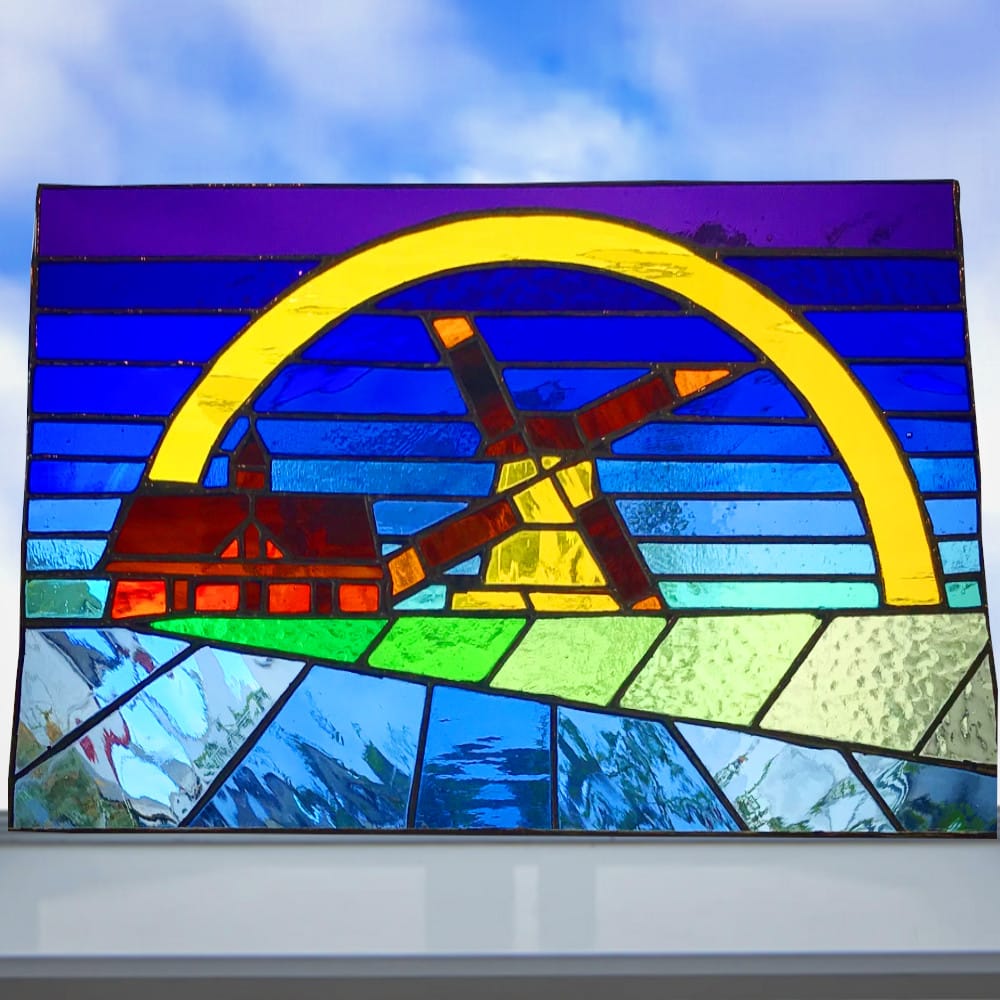 stained glass with windmill and rainbow design