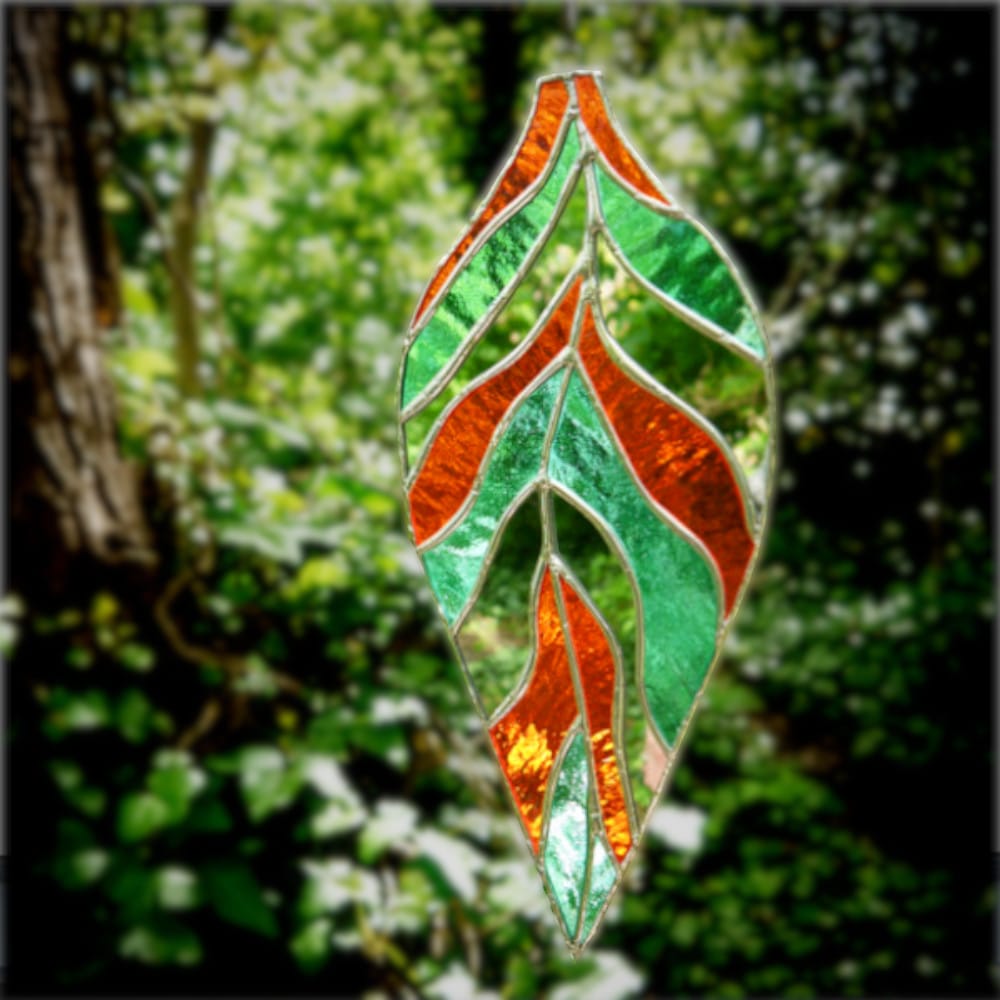 stained glass leaf hanging in garden
