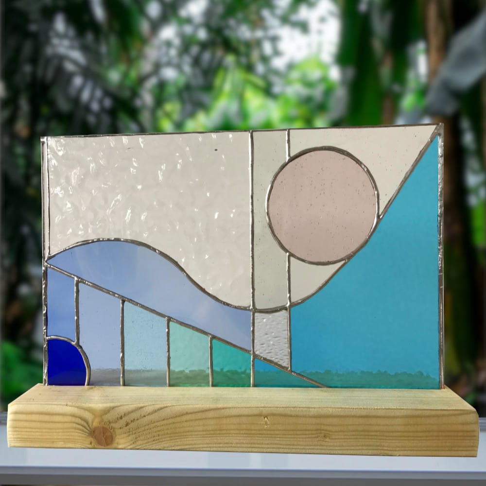 stained glass piece with a wave and circle design