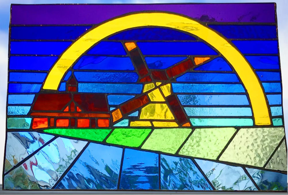 stained glass with windmill and rainbow design